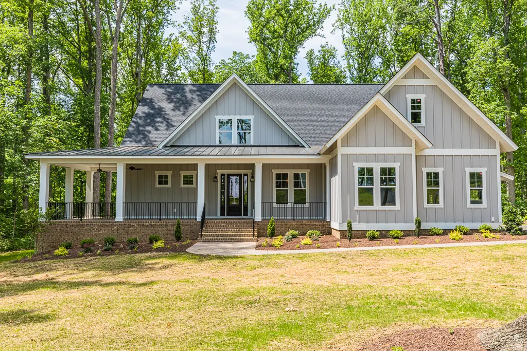 A large house with many trees in the background